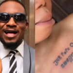 Junior Pope, an actor, reacts as a female fan tattoos his complete name on her chest.