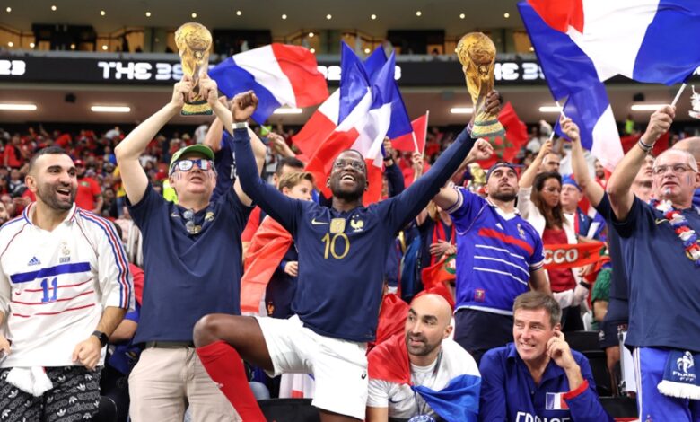 French fans waved tricolor flags and set off flares on the Champs-Elysees